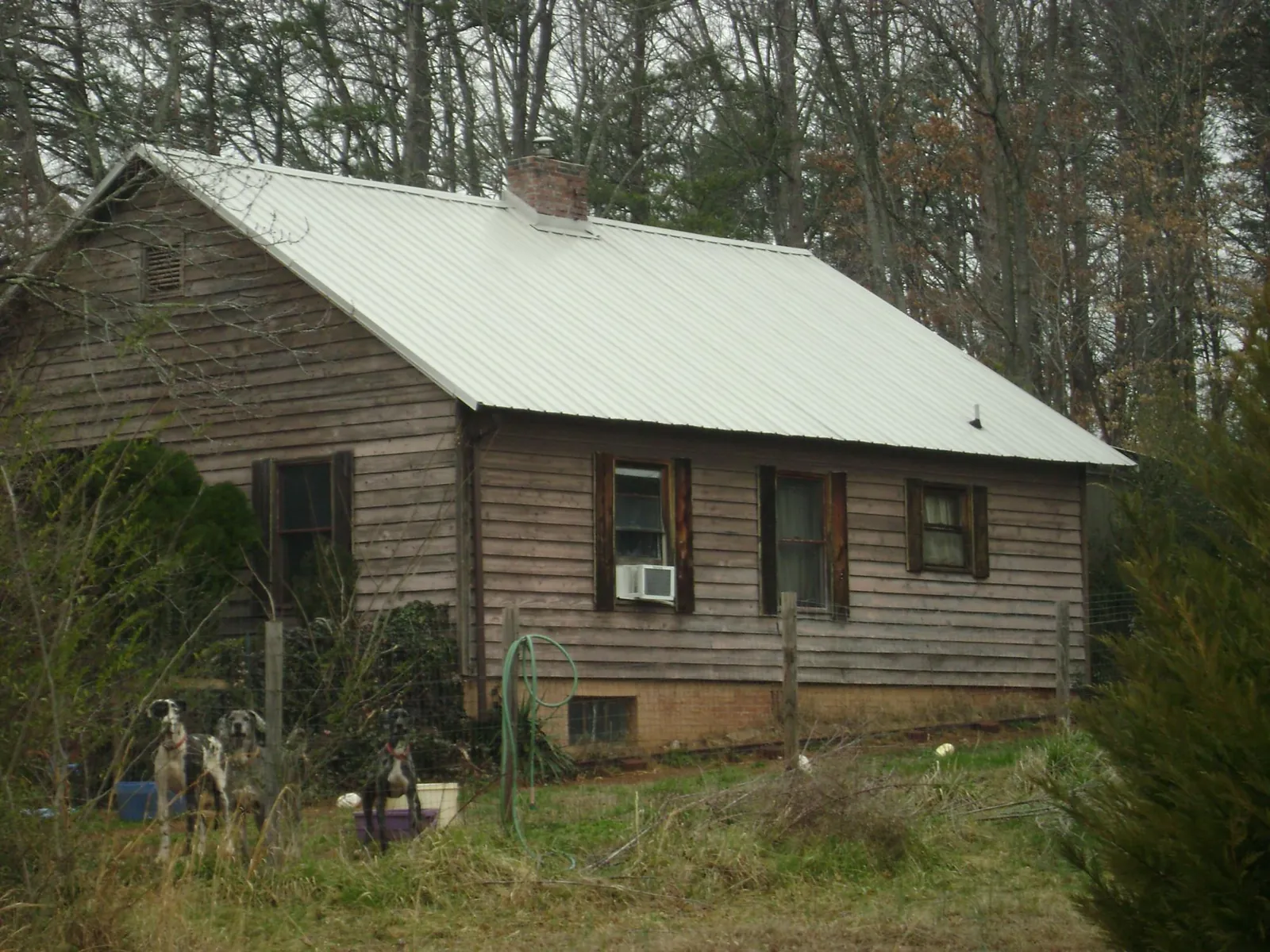 White metal roof on an old wood sided farmhouse, from a Asphalt Shingle Roof Repair job in Middlesex